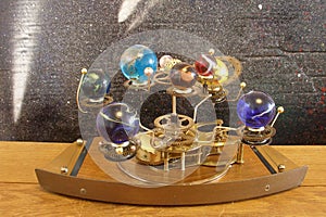 Orrery steampunk art clock with planets of the solar system.