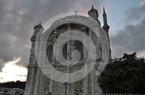 Ortakoy mosque,back view,under grey dark clouds in Istanbul.