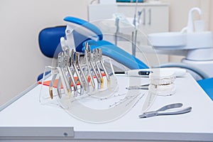 Orthodontist Dental set of clamps and pliers and other tools on the working table surface