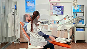 Orthodontist discussing MRI scan with patient before surgery