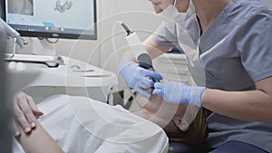 Orthodontist using 3D intraoral scanner for scanning teeth patient's. Modern dental clinic with equipment. Dentistry and