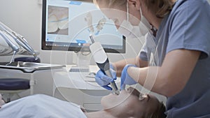 Orthodontist using 3D intraoral scanner for scanning teeth patient's. Modern dental clinic with equipment. Dentistry and