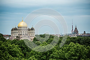 Orthodox Cathedral golden dome above Riga city trees.