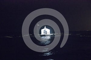 Orthodox chapel on an islet at night