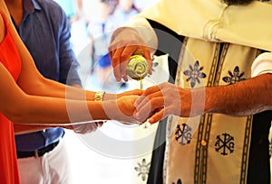 Orthodox christening icon - priest puts baptism oil on the hand of godmother