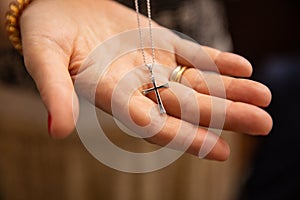 Orthodox christenings of a child, a cross in his father`s hand photo
