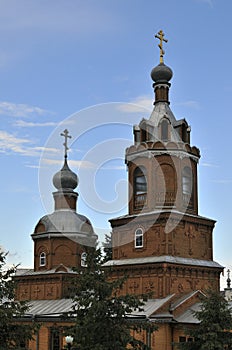 Orthodox Christian Cathedral with golden domes and crosses against the sky, spring day. Tserkov` Smch.kharlampiya, Tsivilsk,