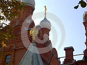 Orthodox Christian Church with white domes, golden crosses and coat of arms of Russia double-headed eagle. Located in Pushkin, sub
