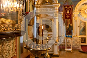 Orthodox Church. Christianity. Festive interior decoration with burning candles and icon in traditional Orthodox Church