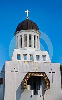 Orthodox church with a cross on the dome against the blue sky.