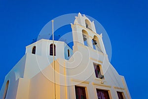 Orthodox church dome and tower in Oia town Santorini Greece