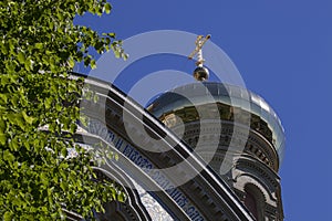 Orthodox church golden dome and cross on blue sky