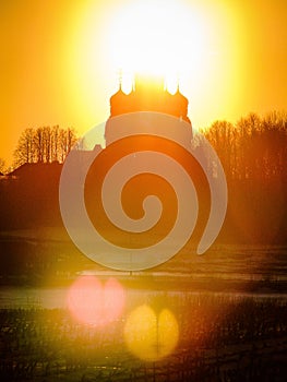 Orthodox Church in honor of Saint George in the Kaluga region (Russia) at sunset.