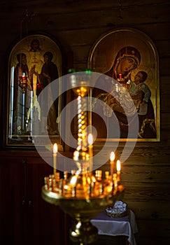 Orthodox church, icons of saints, gilding, burning candles