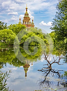 The Orthodox church is reflected in the lake. Peterhof.