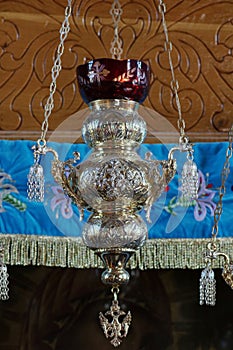 Orthodox church. Silver hanging oil lamp - Bujoreni Monastery, landmark attraction in Romania