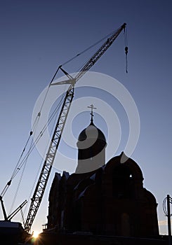 Orthodox church under construction near a modern residential building. Filmed in the summer of 2020 in Chelyabinsk.