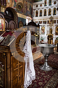 Orthodox Church wedding paraphernalia â€“ baby bath towel, a cross, bible on the altar