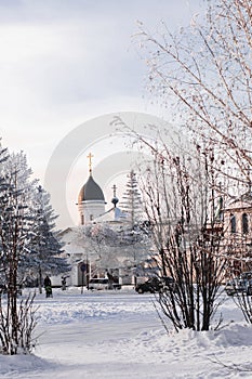 Orthodox church. Winter landscape. Winter road and trees covered with snow.