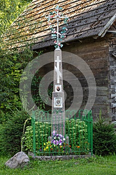 an orthodox cross stands by the road in a village in Poland