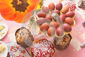 Orthodox easter still life. Traditional Easter cakes, Easter eggs, flowers, tulip in vase on the table