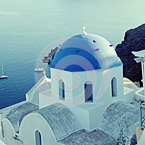 Orthodox greek church in the Oia village, Santorini, sea view.