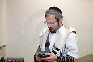 Orthodox cleans the place of tefillin after prayers photo