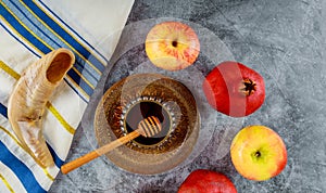 Orthodox Jewish holiday honey on the pomegranate and apples. Jewish new year Rosh Ha Shana shofar