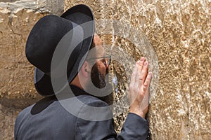 Orthodox Jewish man praying inside the synagogue at the Western Wall Wailing Wall in Jewish Quarter, Old City, Jerusalem, Israel