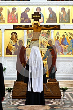 Orthodox priest Metropolitan prays in the church before the Crucifixion