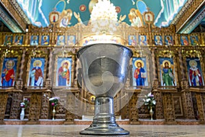 A pot of water in which the child to be baptized is immersed.