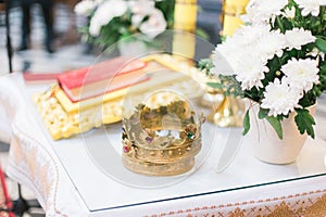 Orthodox wedding ceremonial crown and the Bible, ready for a crowning ceremony