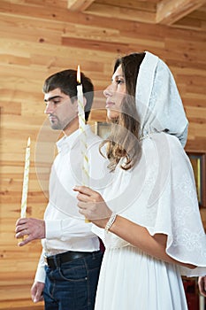 Orthodox wedding ceremony. man and woman with candles at church
