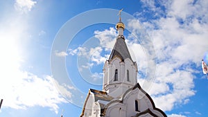 Orthodox white Church on blue sky background. Stock footage. Religious theme associated with orthodoxy and christianity