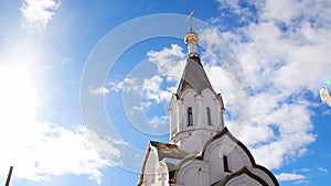 Orthodox white Church on blue sky background. Stock footage. Religious theme associated with orthodoxy and christianity