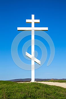 A wooden cross on top of a hill