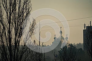 Orthodoxy church during sunset an foggy weather