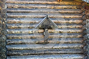 Orthodoxy cross on a background log walls. photo