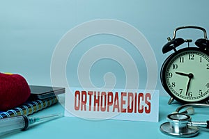 Orthopaedics Planning on Background of Working Table with Office Supplies