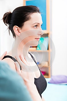 Woman having head massage from physiotherapist photo