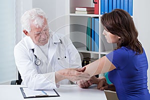 Orthopaedist diagnosing painful elbow