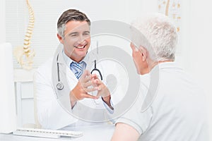 Orthopedic doctor discussing with senior patient