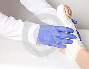 An orthopedic doctor examines a bruised toe. Big toe sprain and fracture concept, close-up, medical, copy space