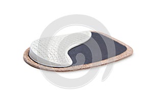 Orthopedic leather heel pad from corns for the correction of different lengths of legs isolated on white background.