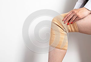 Orthopedic medical kneecap on the leg of a girl. Micromassage and warming effect in inflammatory diseases of the knee