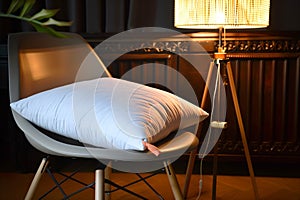 orthopedic pillow on a designer chair, stylish lamp illuminating the scene