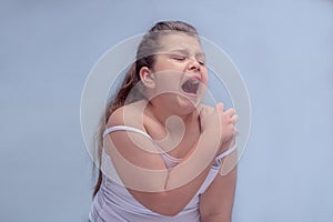 Orthopedic and rheumatological disorders. problem of obesity. girl screams in pain in the shoulder