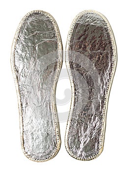 Orthopedic silver insoles isolated on white background. Two warm insoles for shoes