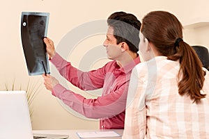 Orthopedic surgeon with a patient in treatment photo