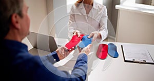 Orthopedist Doctor With Orthopedic Shoe Insole Consulting
